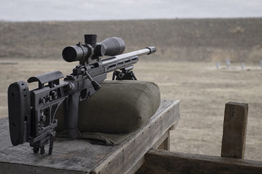 Heavy PRS rifle build resting on a rear support bag on a wooden barricade